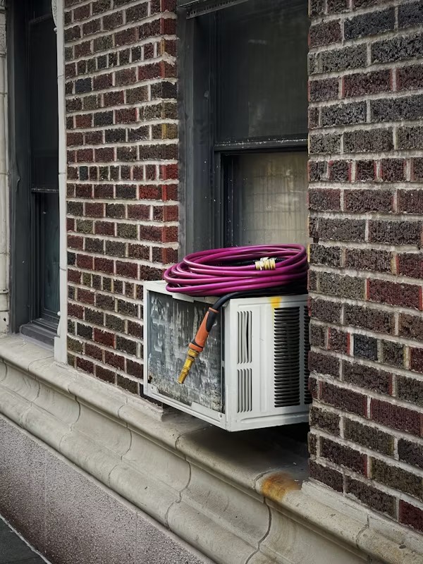 Rinsing HVAC condenser coil during Ripon spring tune-up