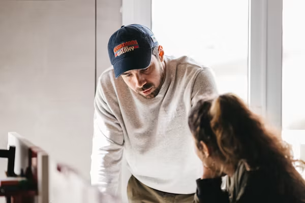 Homeowner discussing HVAC repair or replacement options with a technician