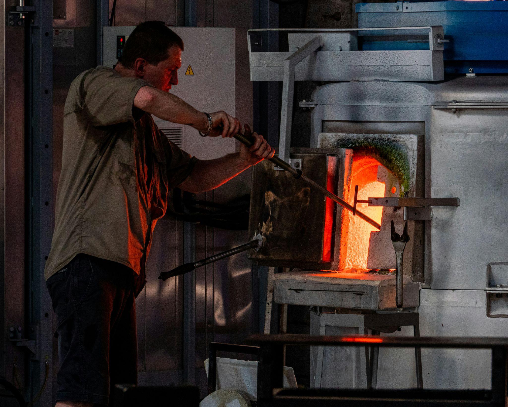 A technician tends to a glowing industrial furnace, representing professional heating service in Turlock.