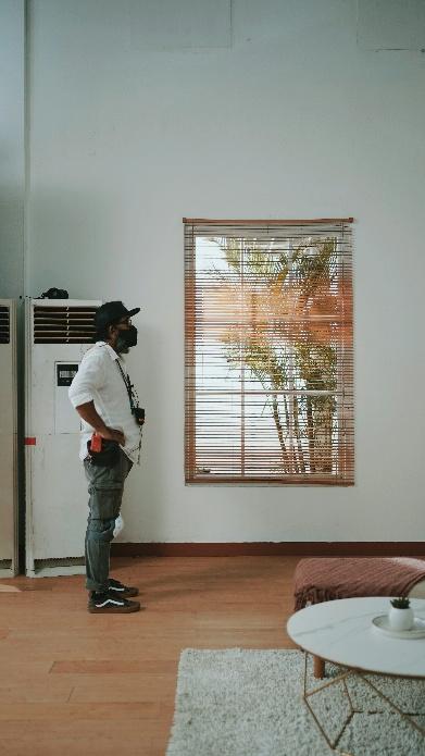 Homeowner checking a dirty air filter affecting HVAC services in California