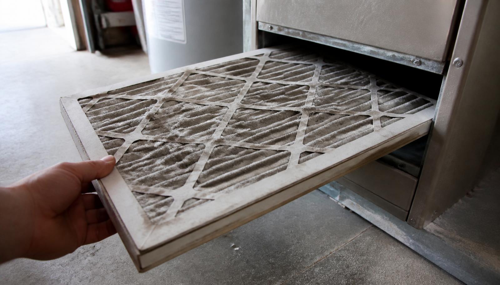 Clogged pleated furnace air filter pulled from a home heating system, a common cause of short cycling