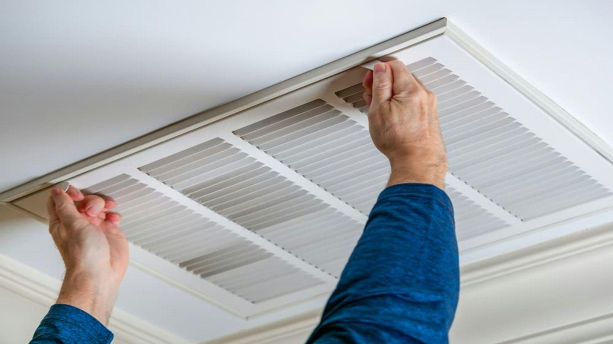 Technician performing a duct inspection in California.