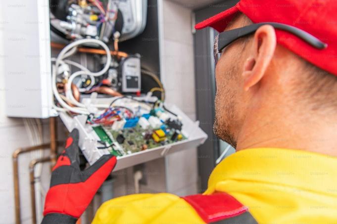 A technician examining a furnace for accurate heating repair in Turlock.