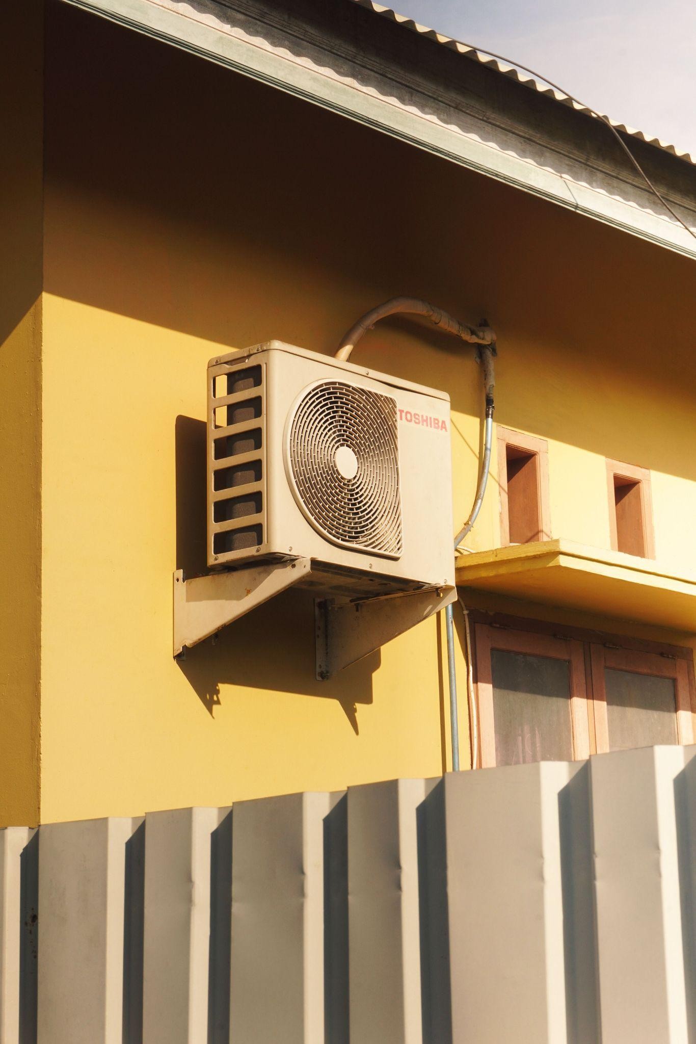 Residential AC condenser unit outside home