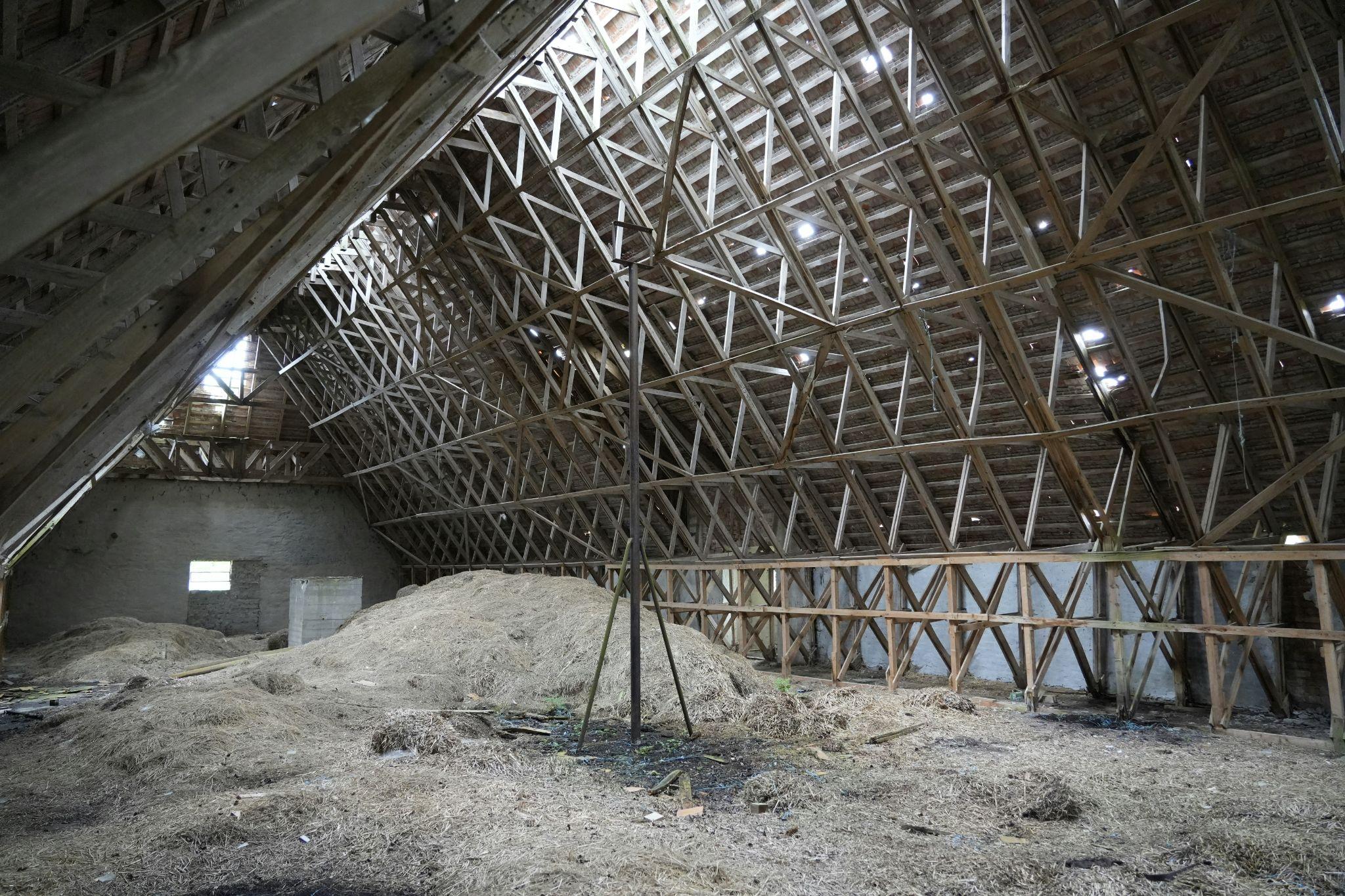 An unfinished attic with exposed roof trusses highlights the importance of proper attic insulation installation in Turlock.