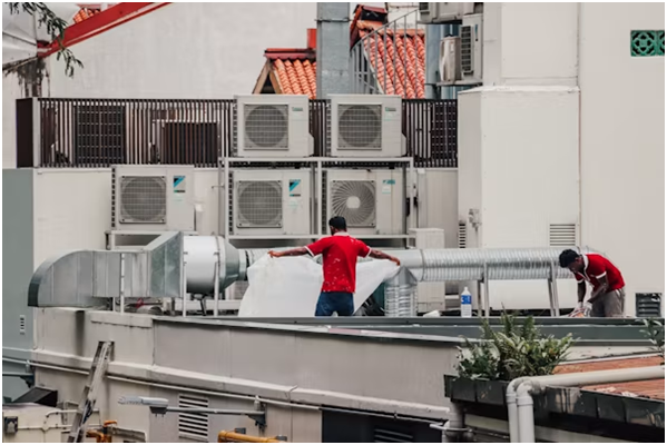 HVAC company in California technician inspecting an air conditioner